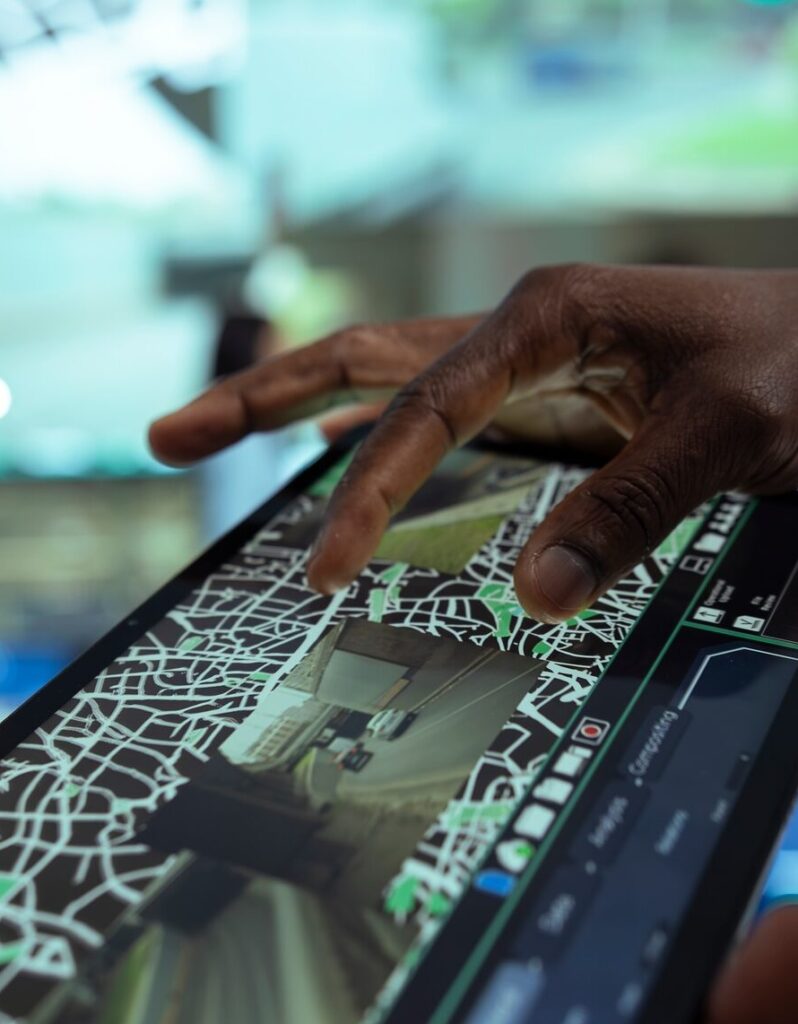 African american leader supervising delivery trucks on a tablet
