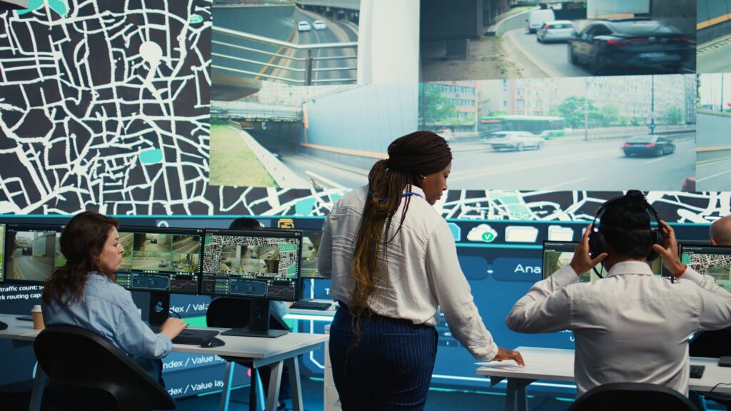 Team leader gives order tracking details to her employees in control center